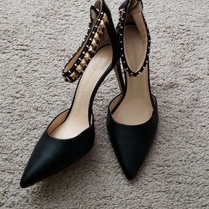 Black heels with gold anklet detail.